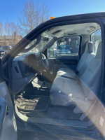 Interior view of a 2006 Ford F-250 with grey seats and dashboard, ideal for work or winter driving.