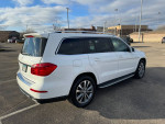 Side view of a 2014 white Mercedes-Benz GL450 4MATIC parked in a spacious lot