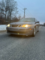 2007 Saab 9.3 car with turbo features parked on a road, showcasing its headlights and sleek design.