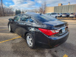 2011 Hyundai Sonata GLS in black, parked outdoors with clean exterior and modern features like Bluetooth radio.