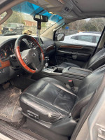 Interior view of a 2011 Nissan Altima Platinum Edition with leather seats and dashboard features