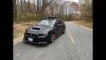 2015 Subaru WRX Limited AWD, black exterior, parked on road surrounded by autumn trees