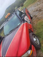 1999 Dodge Dakota truck with 136,000 miles, reliable with cold AC and warm heat, parked on grass.