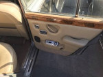 Interior view of a 1973 Rolls-Royce Silver Shadow saloon showcasing beige leather and wooden accents.