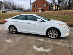 2011 Hyundai Sonata in white, displaying sport design and features, parked on a driveway.