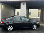 2013 Toyota Corolla LE in great condition with 131,000 miles parked near a car wash.