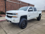 2018 Chevrolet Silverado 1500 Z71 LT 4WD in great condition, lifted, with black rims and a short bed.