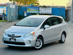 2012 Toyota Prius V Three in silver color parked, showcasing its clean exterior and alloy wheels.