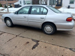 Silver Chevrolet car with 121,000 miles, family-owned since 2003, ready for the highway.