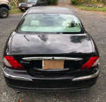 Rear view of a 2003 Jaguar X-Type AWD sedan in black, showcasing its elegant design and good condition.