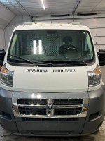 2017 Ram Promaster 1500 front view with minor wear, features bright white exterior and ladder rack