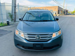 Front view of a 2013 Honda Odyssey EX in good condition, showcasing its clean design and features.
