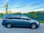 Side view of a 2013 Honda Odyssey EX in good condition with alloy wheels and clean body