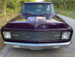 Front view of a modified 1971 Chevrolet C10 Shortbed pickup truck in purple, showcasing its custom design and new features.