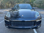 Front view of a black 2015 Porsche Cayenne S AWD, showcasing its sleek design and refined features.