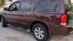 2015 Nissan Armada HD in great condition, maroon color, with alloy wheels and tinted windows, showcasing rear view.