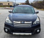 Front view of a 2014 Subaru Outback 2.5i AWD in Deep Indigo Pearl color, showcasing its stylish design.