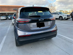 2023 Chevrolet Bolt 2LT in Gray Ghost Metallic parked, showcasing its modern design and electric vehicle features.