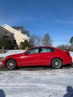 2010 Infiniti G37x AWD in red, parked on a snowy driveway, featuring a sporty design and clean title.