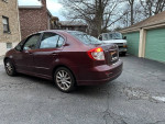 2008 Suzuki SX4 sedan parked, great running condition with new tires and regular maintenance, for sale.