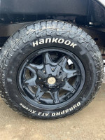 Close-up of a Hankook off-road tire on a 2005 Toyota Tacoma, showcasing its rugged design and new tread.