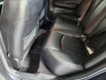 Interior view of 2009 Infiniti G37x showing spacious black leather back seats and floor mats.