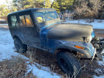 1985 Jeep CJ7 with Chevy 350 V8, Holley Sniper fuel injection, parked in snowy terrain.