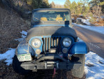 Front view of a 1985 Jeep CJ7 with a Chevy 350 V8 engine, featuring new parts and off-road capabilities.