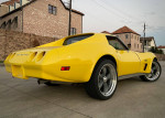 1974 Chevrolet Corvette in yellow, fully restored, showcasing sleek design and modern upgrades for performance and comfort.