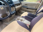 Interior of a 2006 Honda CR-V LX showing clean seats and dashboard, perfect for commuting or family use.
