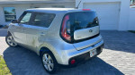 2017 Kia Soul in silver, showcasing the rear view outside a house with a clean title and low mileage.