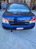Rear view of a blue 2006 Subaru Impreza 2.5i AWD parked in a driveway