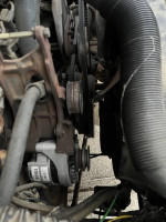 Close-up view of the engine belts and components in a 1987 Ford F250 pickup truck.