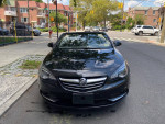 2016 Buick Cascada Premium convertible parked on the street, showcasing its sleek design and clean exterior.