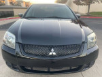Front view of a 2011 Mitsubishi Galant in black, featuring a stylish grille and clean finish.