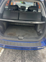 Interior view of the trunk space in a 2006 Kia Sportage with rear seats folded down.