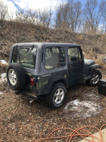 1994 Jeep Wrangler in green with hard and soft tops, excellent tires, and original features for sale.
