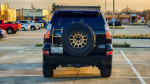 2016 Lexus GX 460 with off-road modifications parked, showcasing its rugged design and Texas plate.