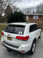 2015 Jeep Grand Cherokee Laredo parked outside, showing rear view with 'Twins on Board' sticker.