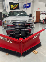 2015 Chevrolet Silverado 2500HD with Boss XT-V plow package in a clean showroom setting