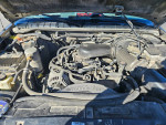 Engine view of a 1999 Chevrolet Blazer showing its components and low mileage updates.