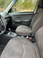 Interior view of a 2013 Kia Soul, showing clean seats and dashboard, detailed condition of the car.