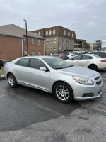 2013 Chevrolet Malibu Eco FWD in good condition with 66,000 miles parked in a lot.