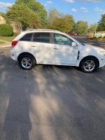 2012 Chevrolet Captiva Sport in white, parked on pavement, showcasing its immaculate exterior and new tires.