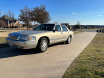 2008 Mercury Grand Marquis LS in gold color parked on a driveway with clean, smoke-free interior.
