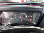 Close-up of a 2005 Jeep LJ dashboard displaying mileage and gauges
