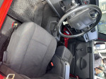Interior view of a 2005 Jeep LJ Unlimited with black seats and dashboard, showcasing a well-maintained design.