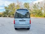 Rear view of a Daihatsu MicroVan showcasing its compact design, perfect for various uses like beach trips or family outings.