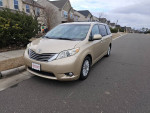2011 Toyota Sienna XLE minivan in gold color parked on a street, featuring navigation and JBL audio system.