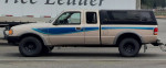 1993 Ford Ranger STX 4x4 with manual transmission, beige color, and blue stripe parked on the street.